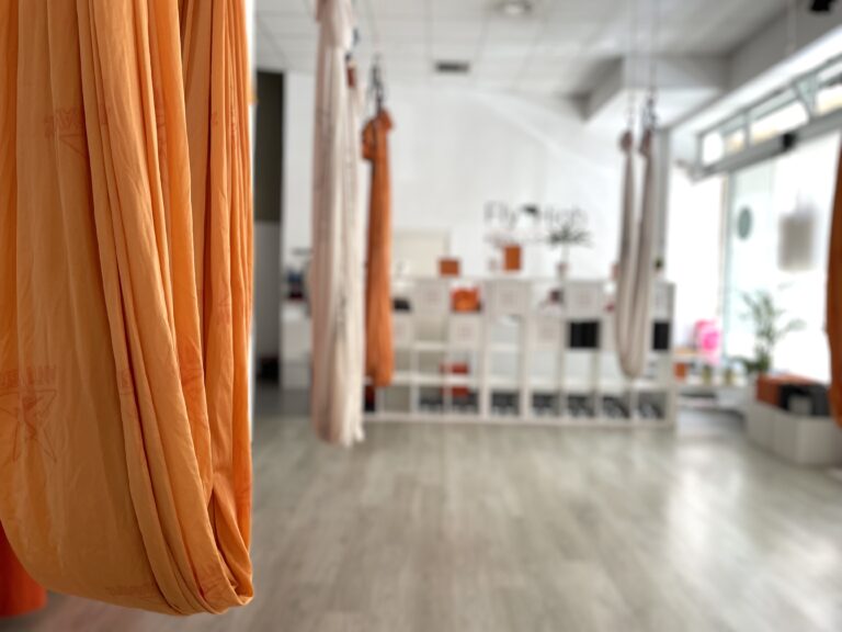 aerial yoga studio with orange silk