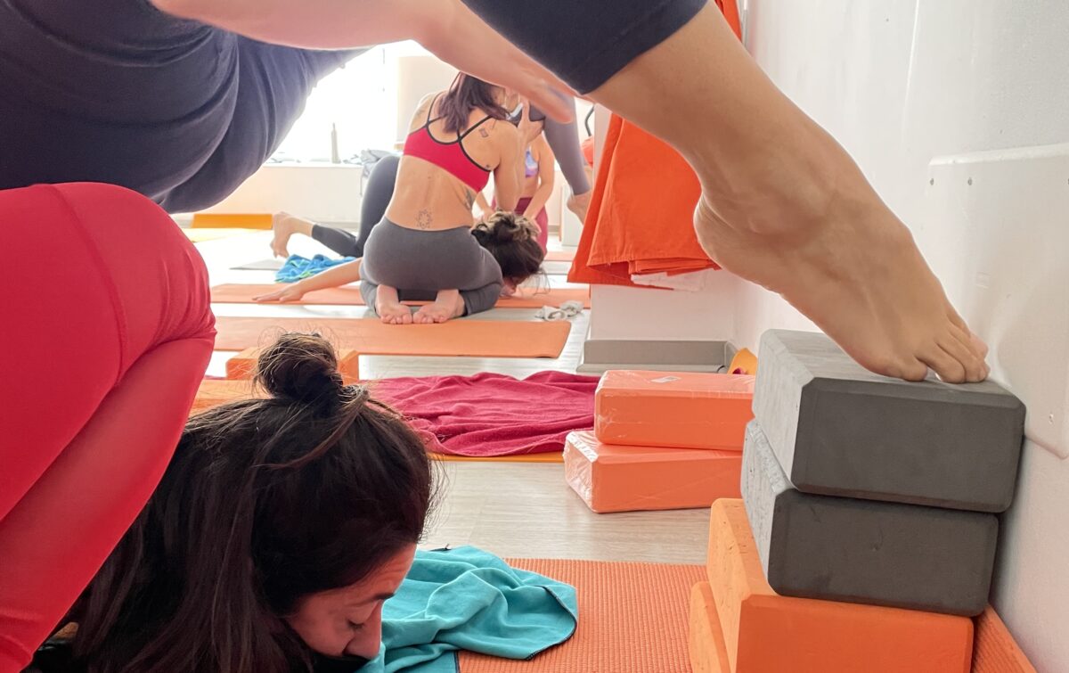 girls flexible doing scorpio exercise of yoga in flexy clases